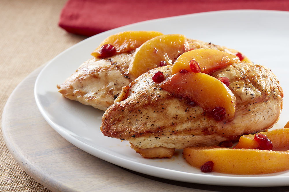 Boneless chicken breasts with lingonberry-peach topping.