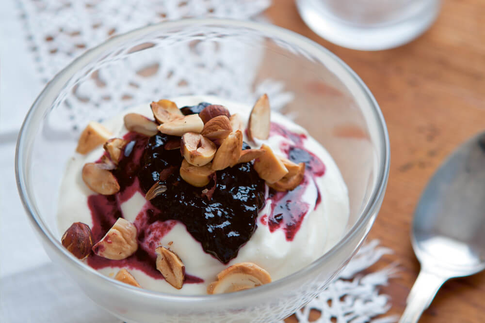 Yogurt, lingonberry jam with blueberries and chopped nuts