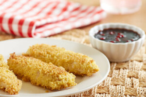 Millet-breaded chicken fingers with lingonberry dipping sauce