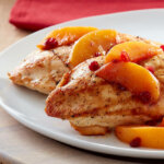 Boneless chicken breasts with lingonberry-peach topping